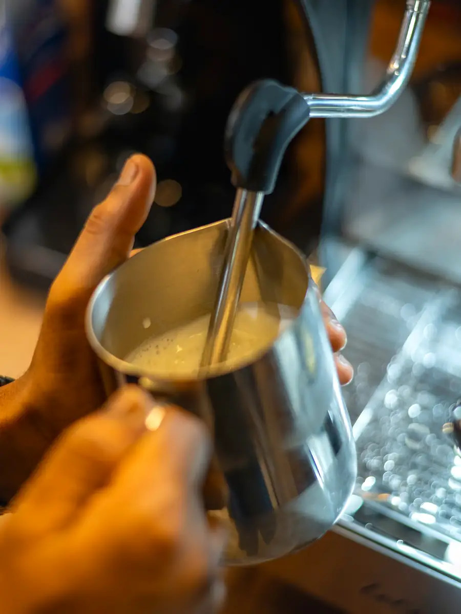 Barista steaming milk