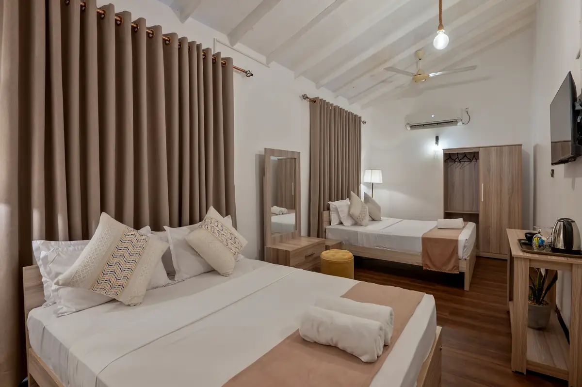 Family Room with double and single beds under high ceilings