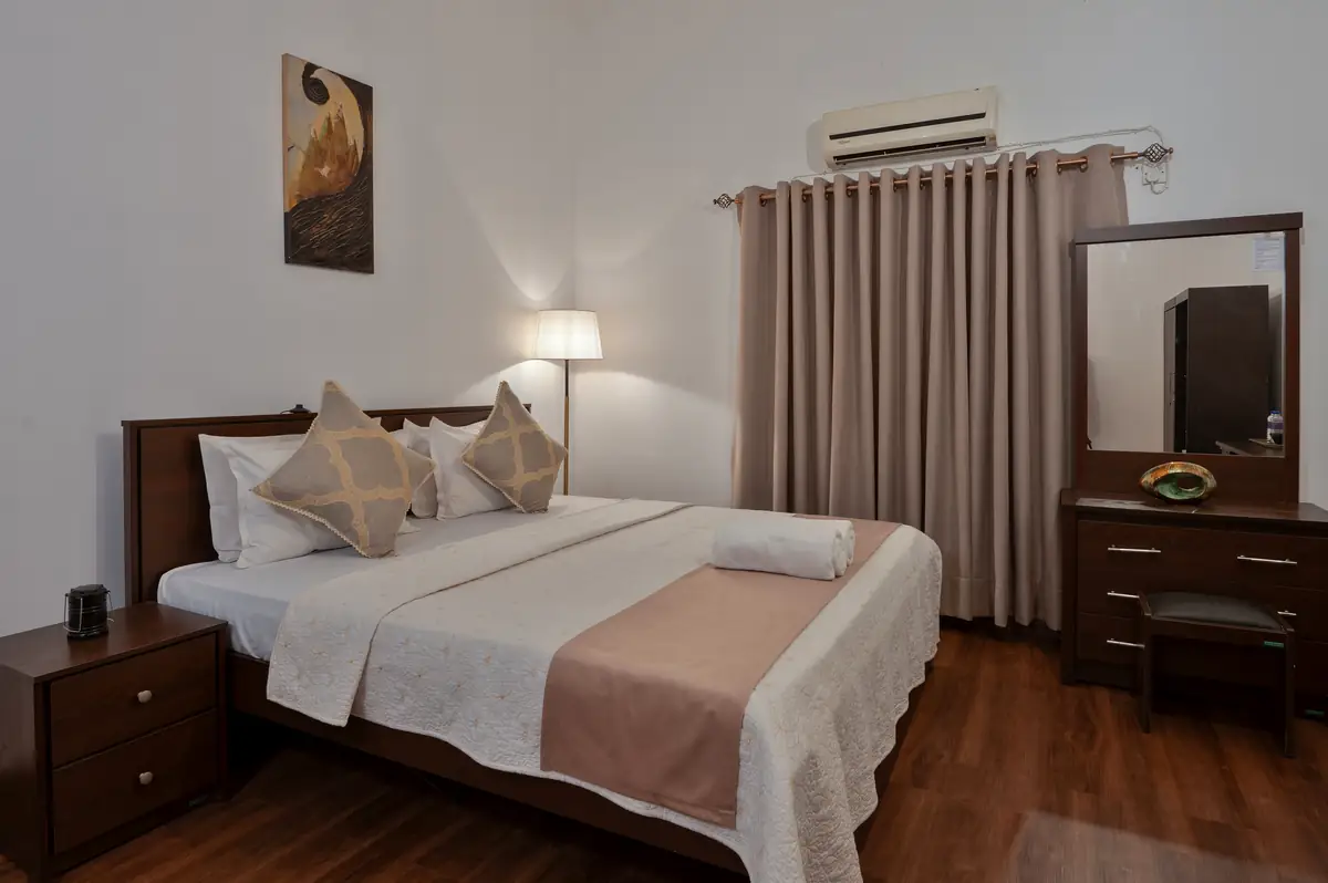 King Room bed with warm wood furniture